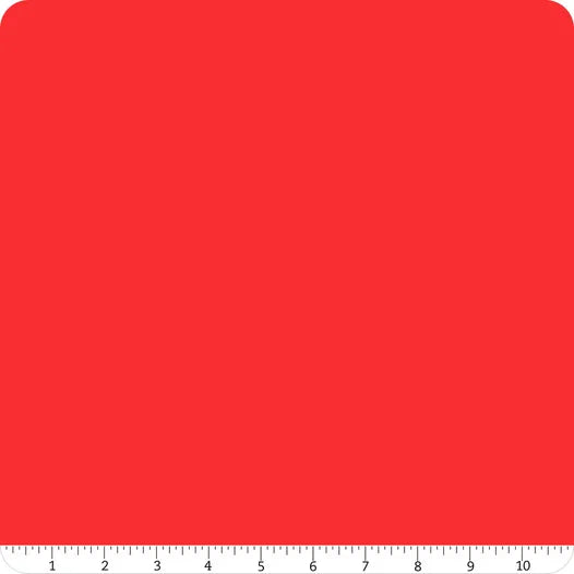 A Confetti Cotton™ Tomato Solid Fabric Yardage by Riley Blake is shown as a red square with rounded top corners and a ruler along the bottom edge, marked from 0 to 11 inches.