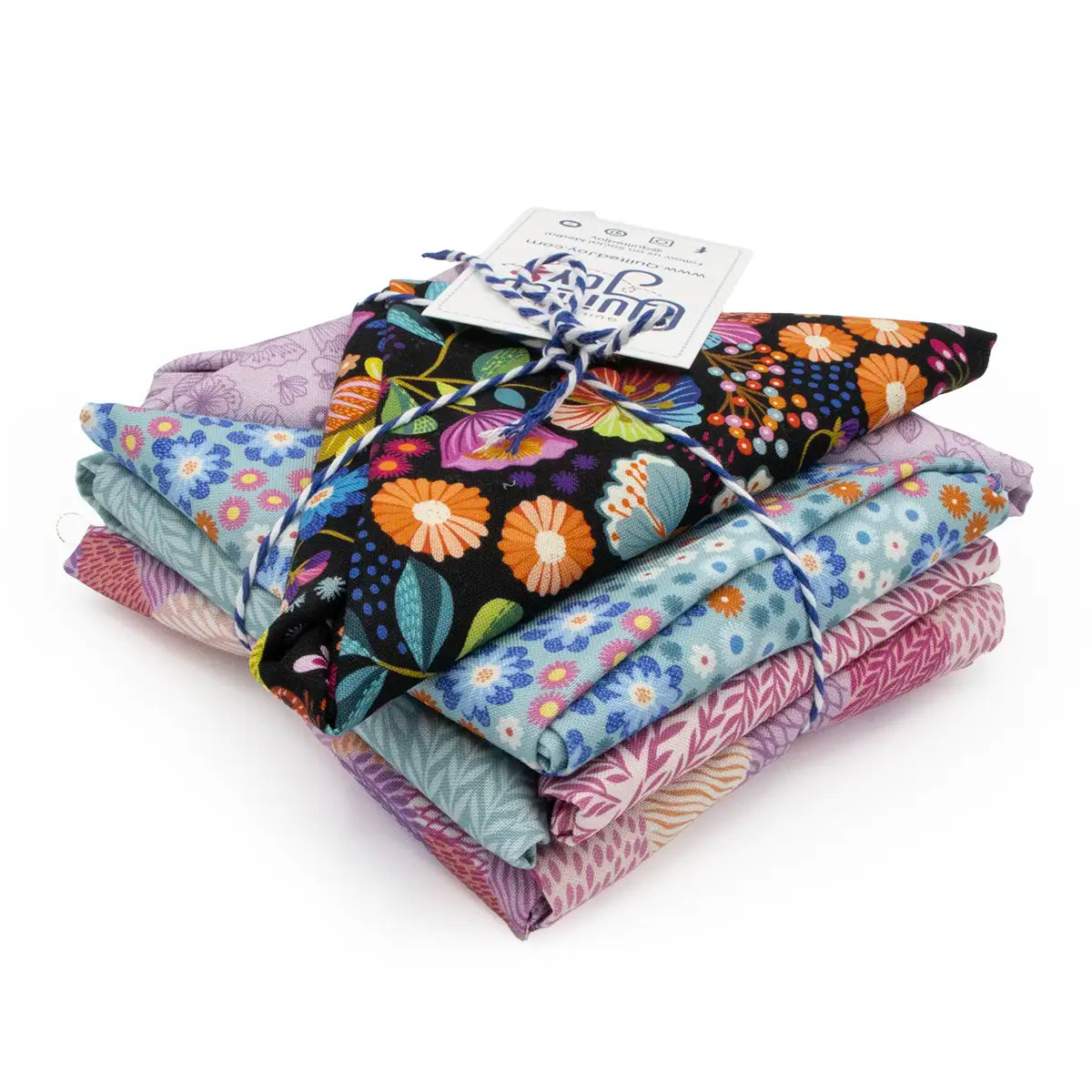 A neatly stacked bundle of colorful patterned fabric pieces tied together with blue and white string. The fabrics feature floral and geometric designs in various shades of purple, blue, and black.