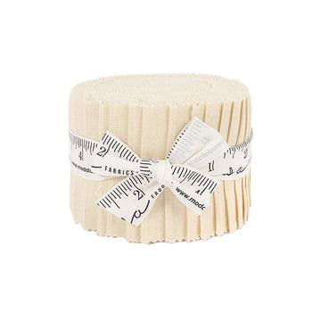 The Bella Solids Natural Junior Jelly Roll by United Notions features cream fabric strips rolled and tied with a measuring tape ribbon, displayed on a white background—ideal for quilting projects.