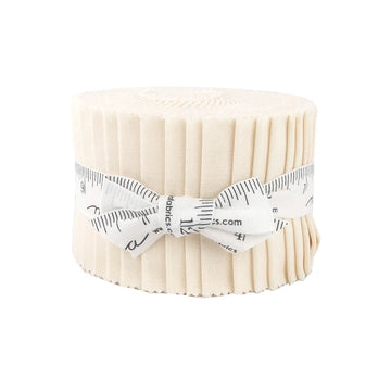 The Bella Solids Ivory Junior Jelly Roll by United Notions is a bundle of fabric strips, neatly rolled and tied with a measuring tape ribbon, shown on a white background.