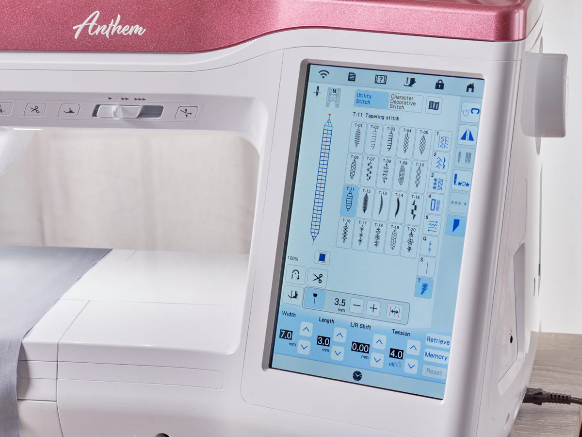 A close-up of the Baby Lock Anthem Sewing & Quilting Machine with a digital touchscreen showing stitch options, settings, and StitchSync Regulation. The white machine has a pink top labeled Anthem. Includes FREE 60 Days of Online Classes.