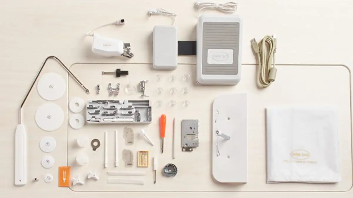 Accessories and parts for the Baby Lock Chorus Sewing Machine by Baby Lock, such as a foot pedal, Compact Digital Dual-Feed System cords, bobbins, presser feet, tools, and manuals, are neatly displayed on a flat surface.
