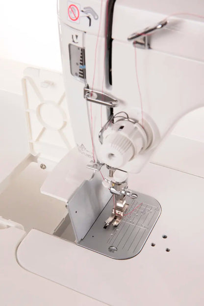 Close-up of the JUKI TL-2000Qi Sewing and Quilting Machine, featuring the needle, presser foot, thread area, and part of the stitch plate.