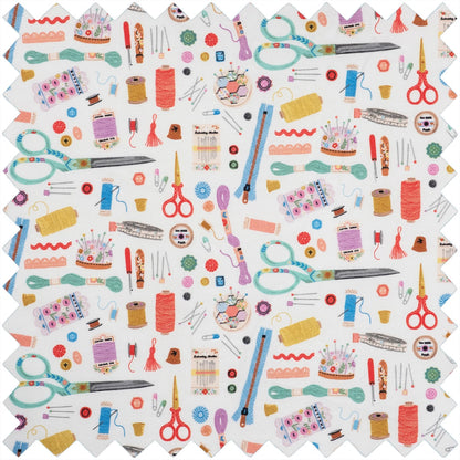 Sewing notions print fabric featuring scissors, thread spools, buttons, and thimbles on white