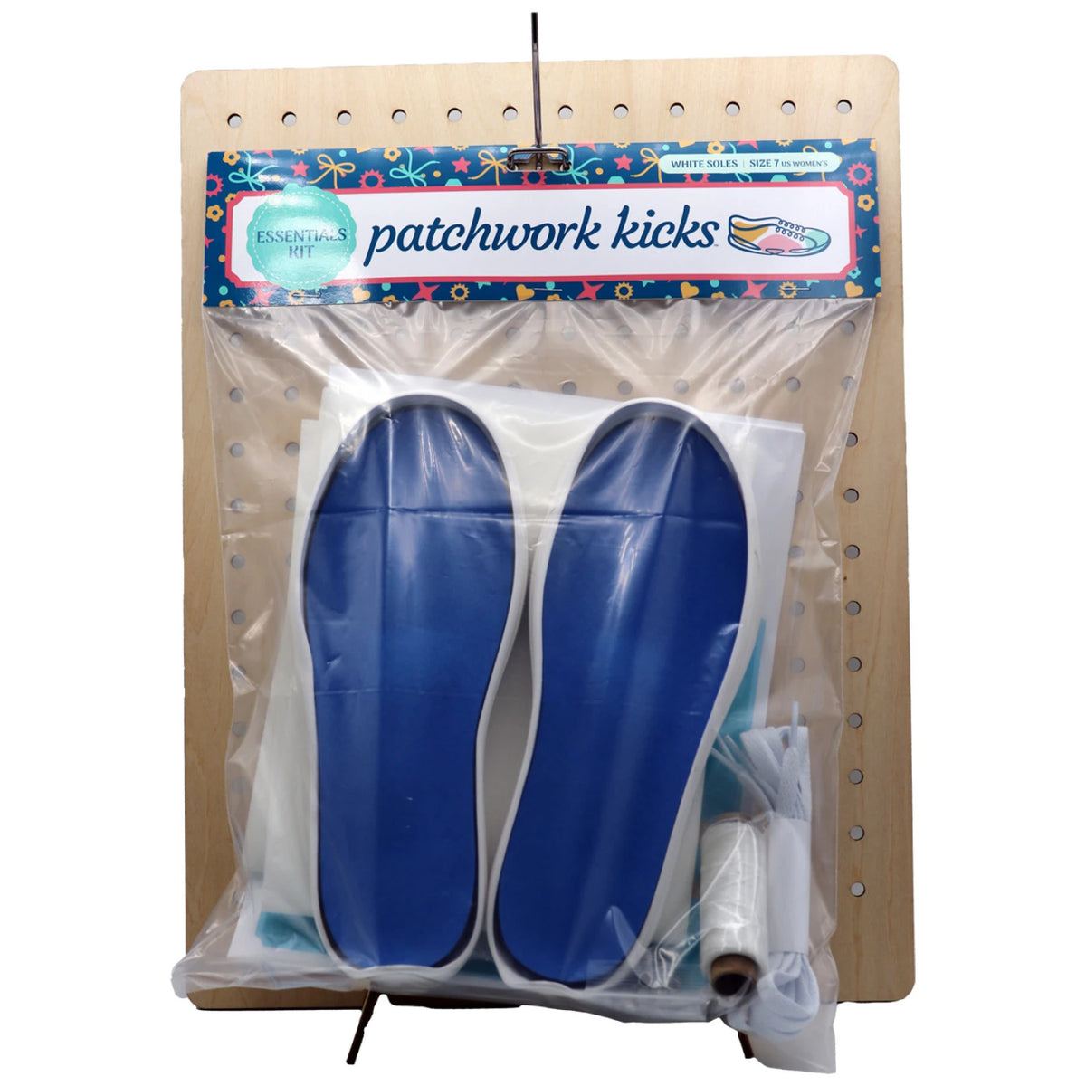 Patchwork Kicks White Essentials Kit components displayed on wooden pegboard with accessories