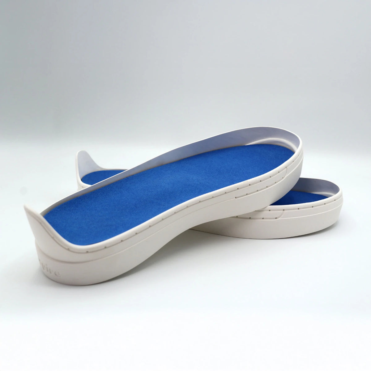 Patchwork Kicks blue shoe insoles with white soles shown from side angle