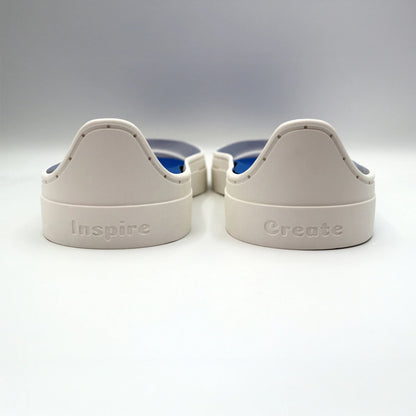 Back view of white Patchwork Kicks soles engraved with Inspire and Create