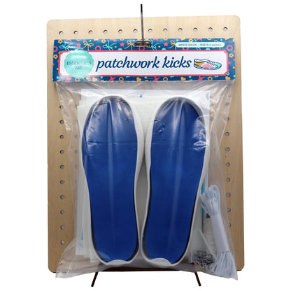 Patchwork Kicks curved blue insoles with white molded soles on pegboard