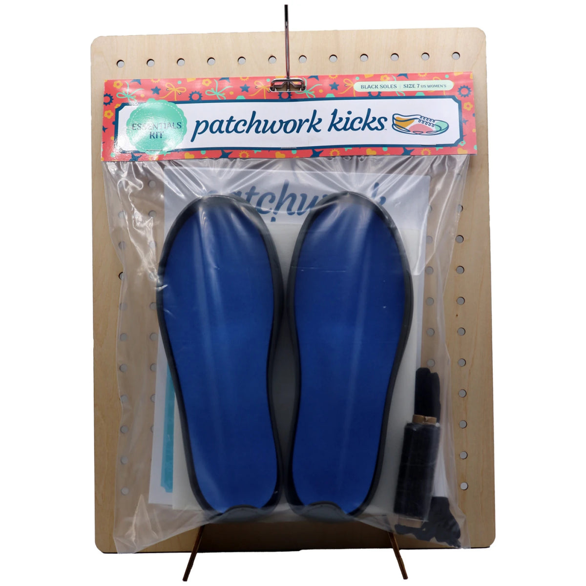 Patchwork Kicks Gray Essentials Kit displayed on wooden pegboard showing kit components