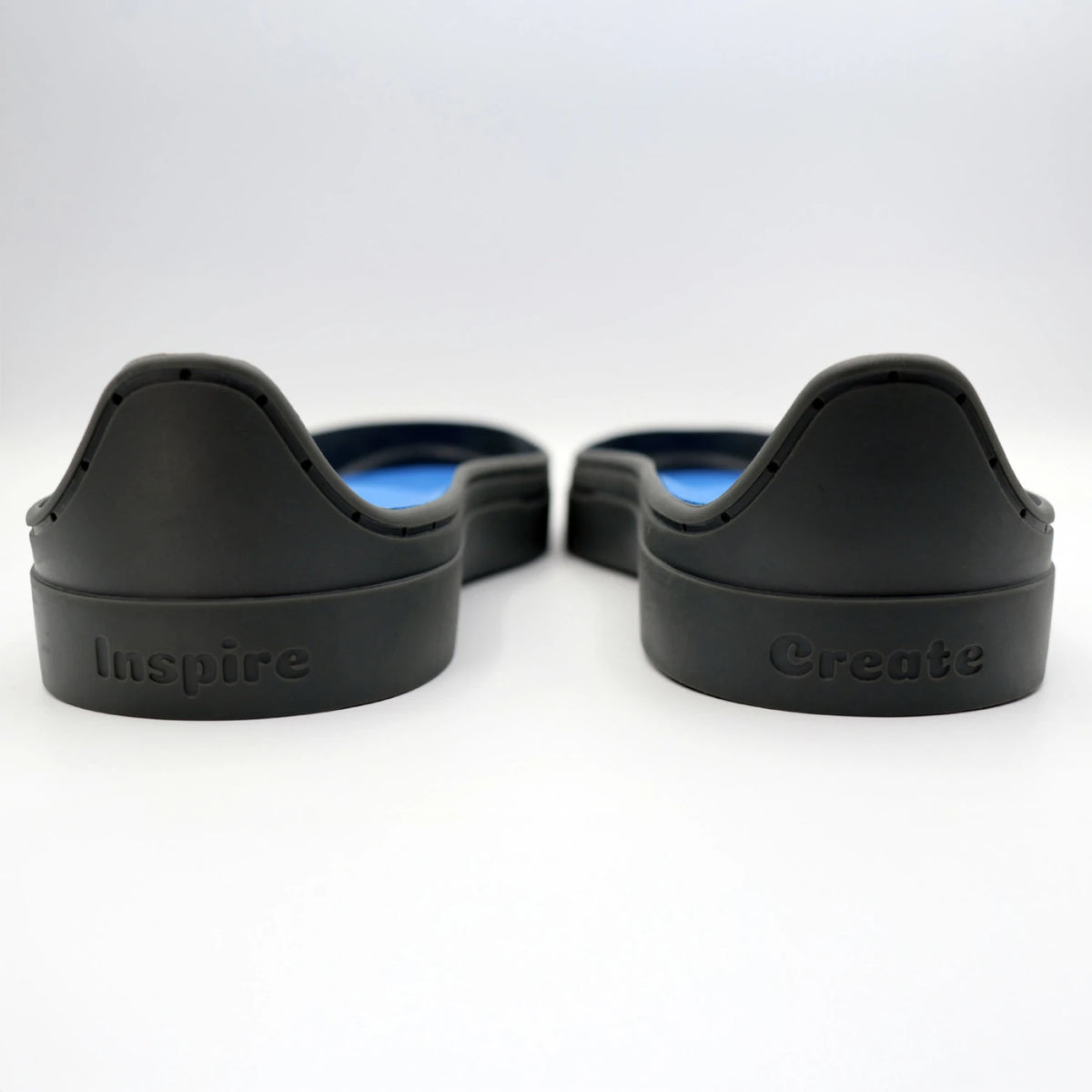 Back of gray Patchwork Kicks soles with Inspire and Create engraved on heels