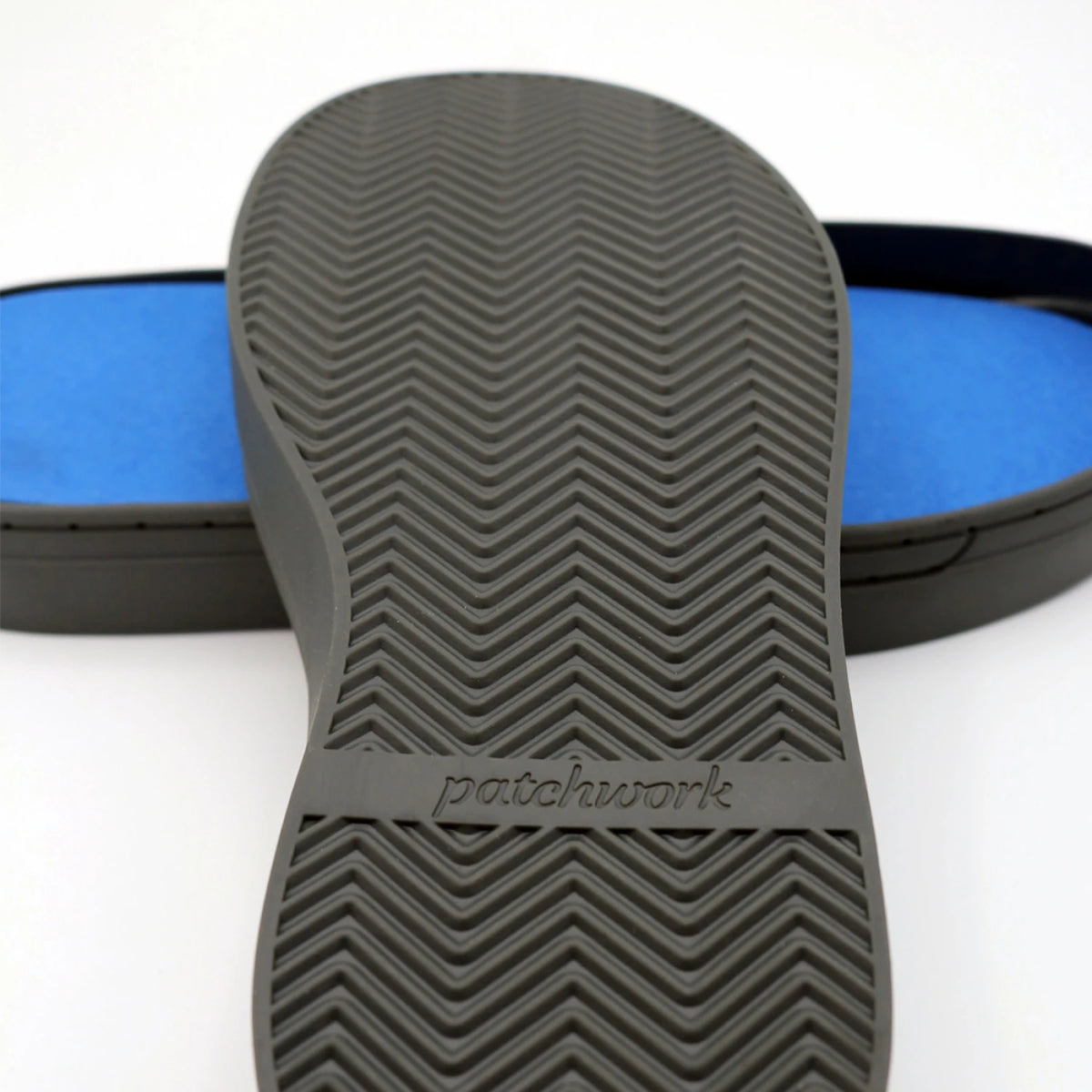 Bottom tread view of gray Patchwork Kicks rubber sole with chevron texture