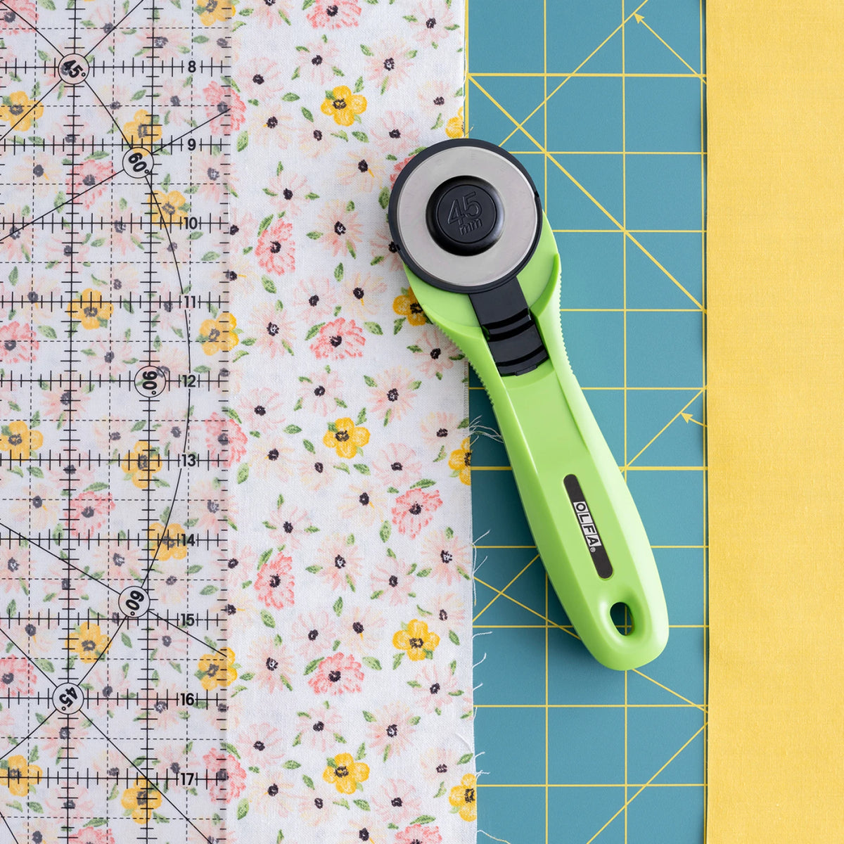 OLFA 45mm rotary cutter ergonomic grip in use cutting fabric