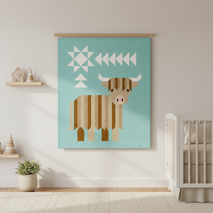Cattle Call Quilt Kit displayed as a wall hanging in a cozy nursery setting