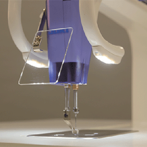 The head of the JUKI Miyabi J-350QVP lit by its LED lights, with a clear acrylic base plate around the needle.