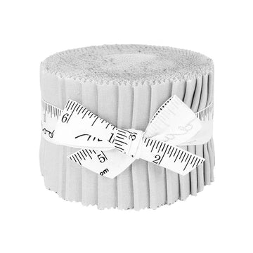 A Bella Solids Zen Gray Junior Jelly Roll by United Notions—fabric strips neatly rolled and tied with a white measuring tape ribbon—rests on a plain white background, ideal for quilting projects.